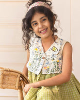 LAAD`S kid in Titalee moss green dress by Laad India, featuring delicate floral embroidery, an eyelet lace bodice, and a gingham checkered dress. A perfect blend of vintage elegance and modern comfort for your little one
