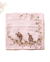 Soft touch of fushia bunny dohar for baby with delicate embroidery featuring two bunnies surrounded by a floral wreath. Made from lightweight, breathable fabric with a satin border perfect for cozy naps and gentle on baby’s skin.