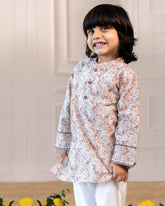 laad`s kid wearing a long-sleeved woodland print kurta with intricate nature-inspired motifs, paired with white pyjama. perfect for festive or special occasions