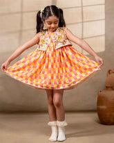Girl wearing the Zinnia party wear DRESS featuring a vibrant checkered kurta with embroidered and printed jacket detailing , perfect for festive occasions and birthday party