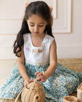 Flora dress has embroidered bunnies hop on the hand-stitched neckline. Cotton lace yoke adds charm. Breezy & comfy for warm days. Easy click-button back. SummerStyle