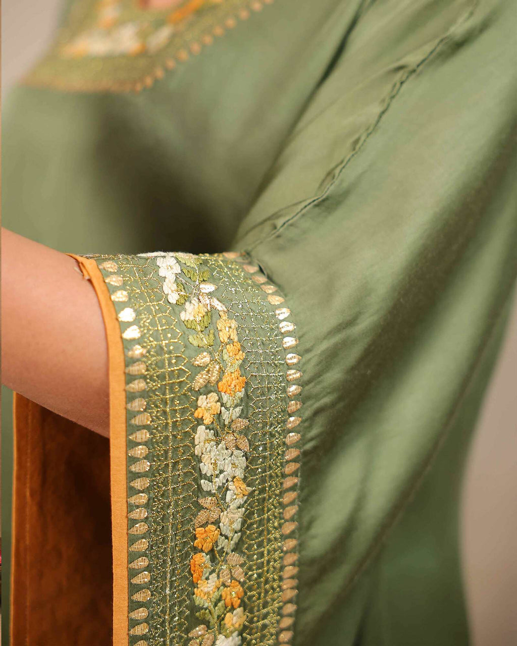 Afghani moss Green designer kaftan set with V-neckline and intricate hand embroidery, paired with Afghani pants featuring ankle-length hem embroidery and zip opening – handcrafted festive ethnic wear for women by Lady Laad