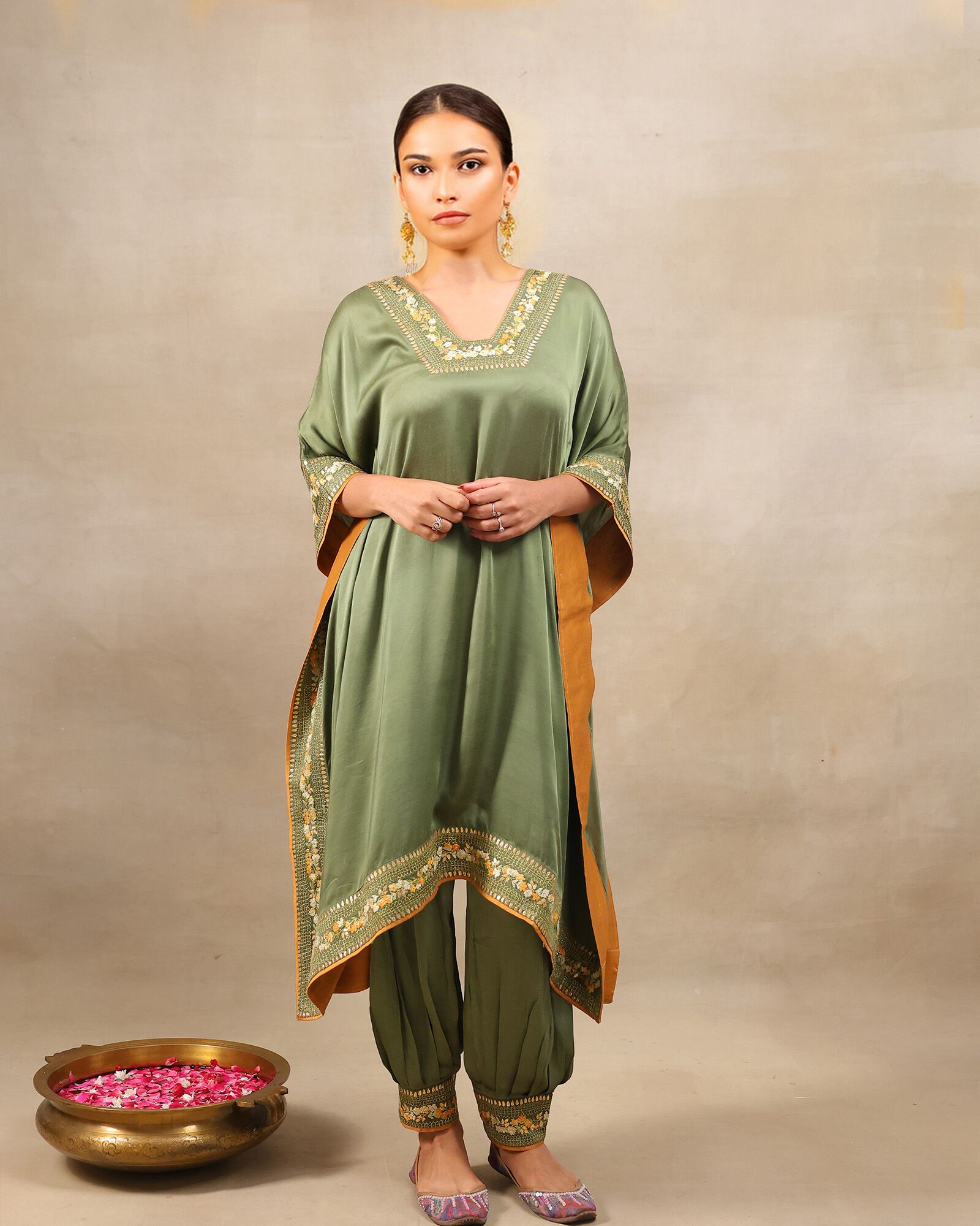 Afghani moss Green designer kaftan set with V-neckline and intricate hand embroidery, paired with Afghani pants featuring ankle-length hem embroidery and zip opening – handcrafted festive ethnic wear for women by Lady Laad