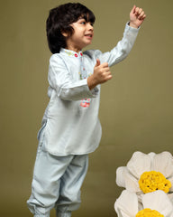 Baby blue bun bandhgala kurta pyjama set   features intricate hand embroidery around the placket and collar with a delightful Bluey motif and shimmering mirror glare details. Fun, colorful buttons add a playful touch, while solid elastic pyjamas ensure comfort and a secure fit