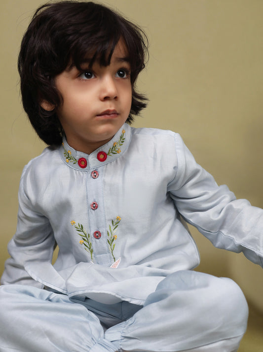 Baby blue bun bandhgala kurta pyjama set   features intricate hand embroidery around the placket and collar with a delightful Bluey motif and shimmering mirror glare details. Fun, colorful buttons add a playful touch, while solid elastic pyjamas ensure comfort and a secure fit.