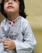 Baby blue bun bandhgala kurta pyjama set   features intricate hand embroidery around the placket and collar with a delightful Bluey motif and shimmering mirror glare details. Fun, colorful buttons add a playful touch, while solid elastic pyjamas ensure comfort and a secure fit