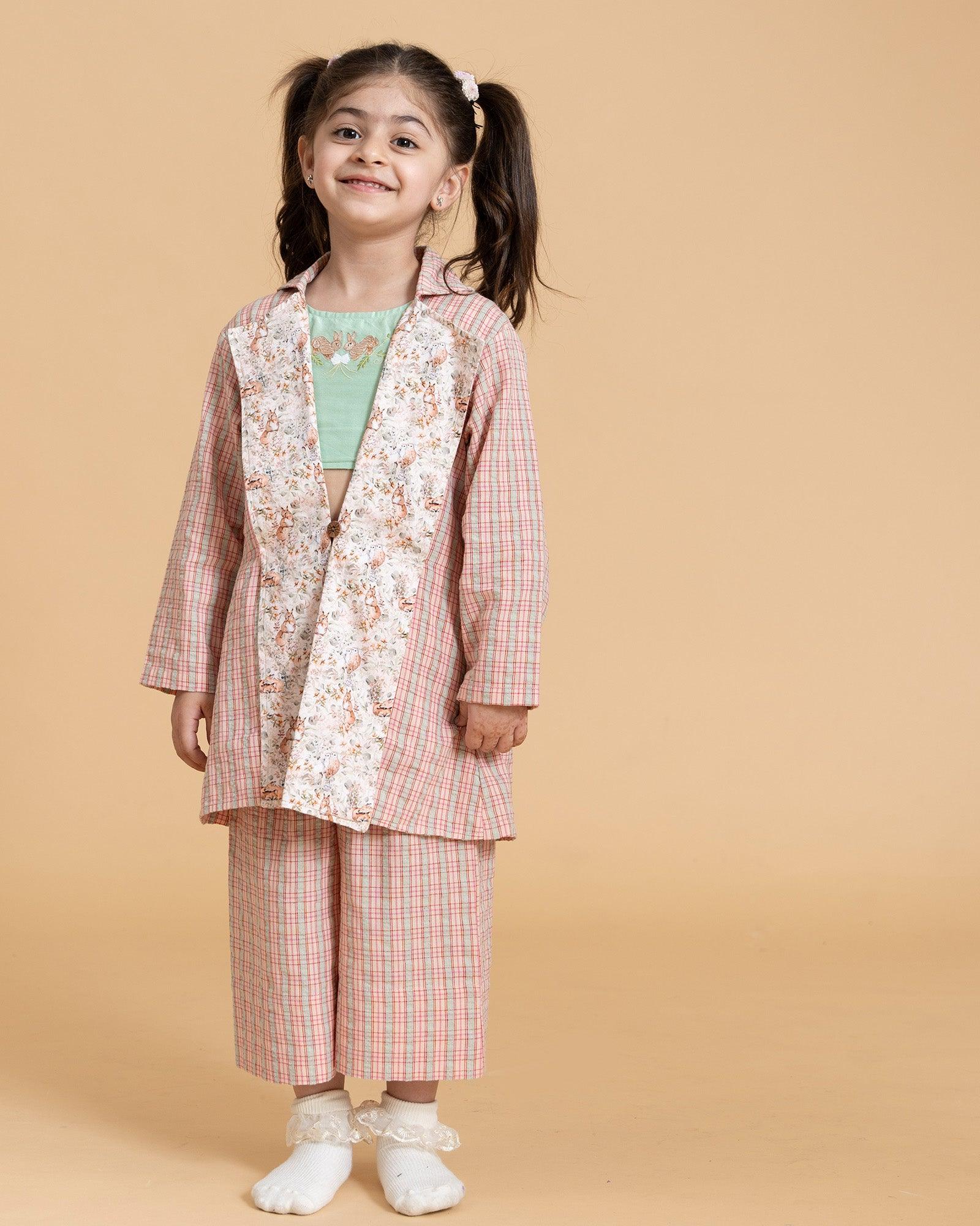 A vibrant Blooming Meadow Co-ord Set featuring a sleeveless silk Chanderi crop top with playful bunny embroidery and intricate threadwork, paired with a long coat featuring a meadow-inspired printed collar. Complete with breezy culottes pants that offer a stylish yet comfortable kidswear fit.