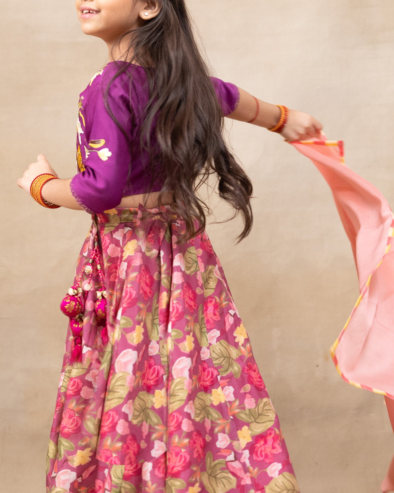 Little girl in a vibrant bulbul voilet bagh lehenga with dupatta featuring  floral print set with  purple embroidered blouse, three-quarter sleeves, paired  peach dupatta – festive ethnic outfit for kids by LAAD