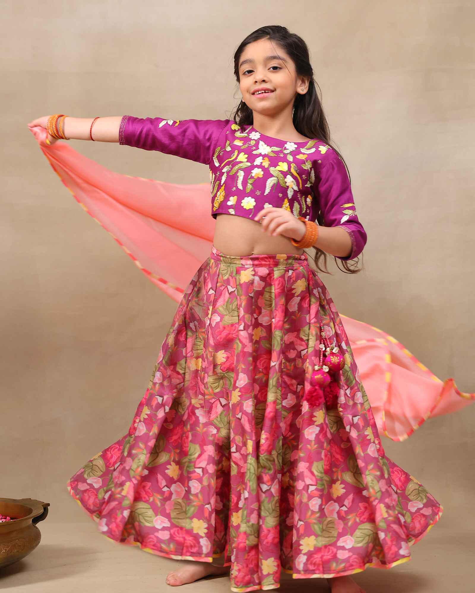 Little girl in purple lehenga  choli with dupatta .This  bulbul voilet bagh lehenga with dupatta features  floral print set with  purple embroidered blouse, purple lehenga choli with dupatta featuring floral charm ,hand  embroidery for girls festive wear- occasions like weddings, pooja and family functions.