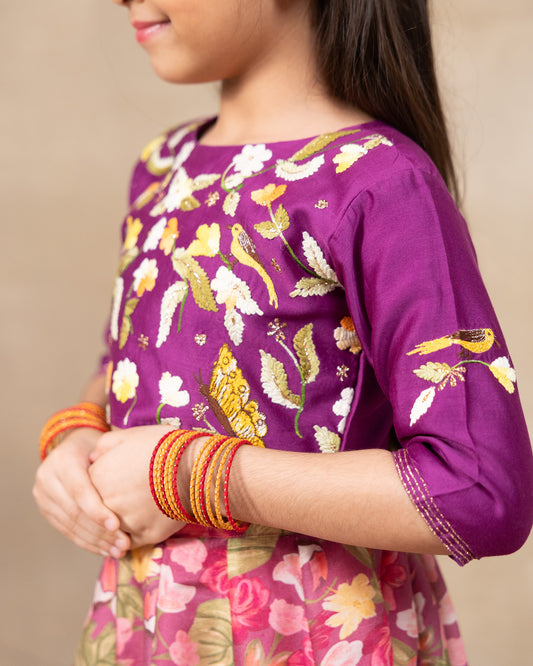 Little girl in a vibrant bulbul voilet bagh lehenga with dupatta featuring  floral print set with  purple embroidered blouse, three-quarter sleeves, paired  peach dupatta – festive ethnic outfit for kids by LAAD