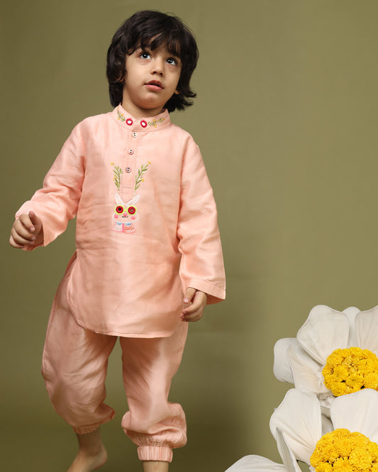 Playful, bright, colorful full-sleeve bandhgala Bunny blush kurta pyjama set. Intricate embroidery featuring bunny blush kurta , shimmering mirror work. Fun buttons add a pop of color. Elastic trousers. Soft cotton lining for comfort by laadindia.com