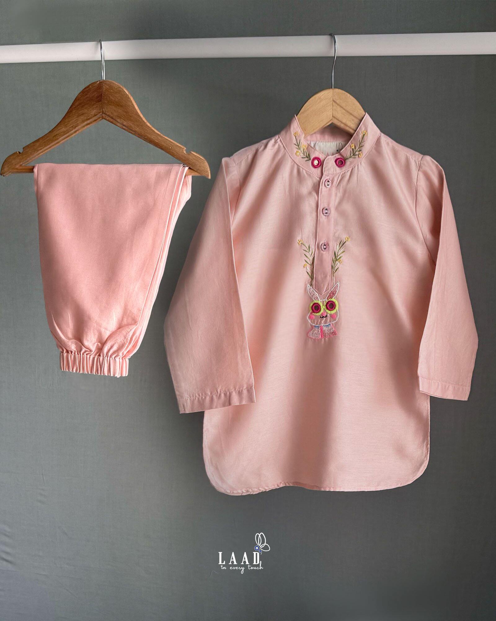 Playful, bright, colorful full-sleeve bandhgala Bunny blush kurta pyjama set. Intricate embroidery featuring bunny blush kurta , shimmering mirror work. Fun buttons add a pop of color. Elastic trousers. Soft cotton lining for comfort by laadindia.com