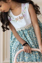 lora dress has embroidered bunnies hop on the hand-stitched neckline. Cotton lace yoke adds charm. Breezy & comfy for warm days. Easy click-button back. SummerStyle