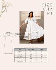 Woman wearing laad`s  white cotton midi dress with floral embroidery, scalloped neckline, and ruffled hem