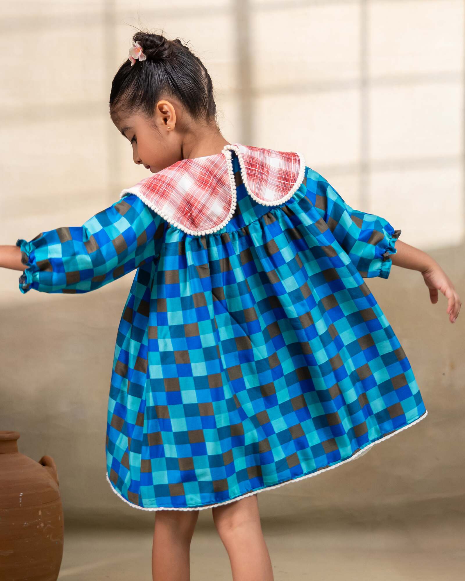 Girl wearing laad`s blue checkered party  dress , girl blue bell dress feature a red plaid Peter Pan collar and lace trim at the hem. perfect travel , occasion wear