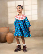 Girl wearing laad`s blue checkered party  dress , girl blue bell dress feature a red plaid Peter Pan collar and lace trim at the hem. perfect travel , occasion wear