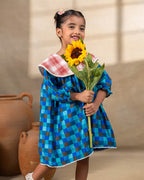 Girl wearing laad`s blue checkered party  dress , girl blue bell dress feature a red plaid Peter Pan collar and lace trim at the hem. perfect travel , occasion wear