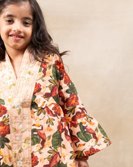 Girl wearing GLUBAGH PEACH SHARARA a handcrafted floral red kimono style top with embroidered neckline and flared ivory sharara pants – ethnic festive kidswear by LAAD
