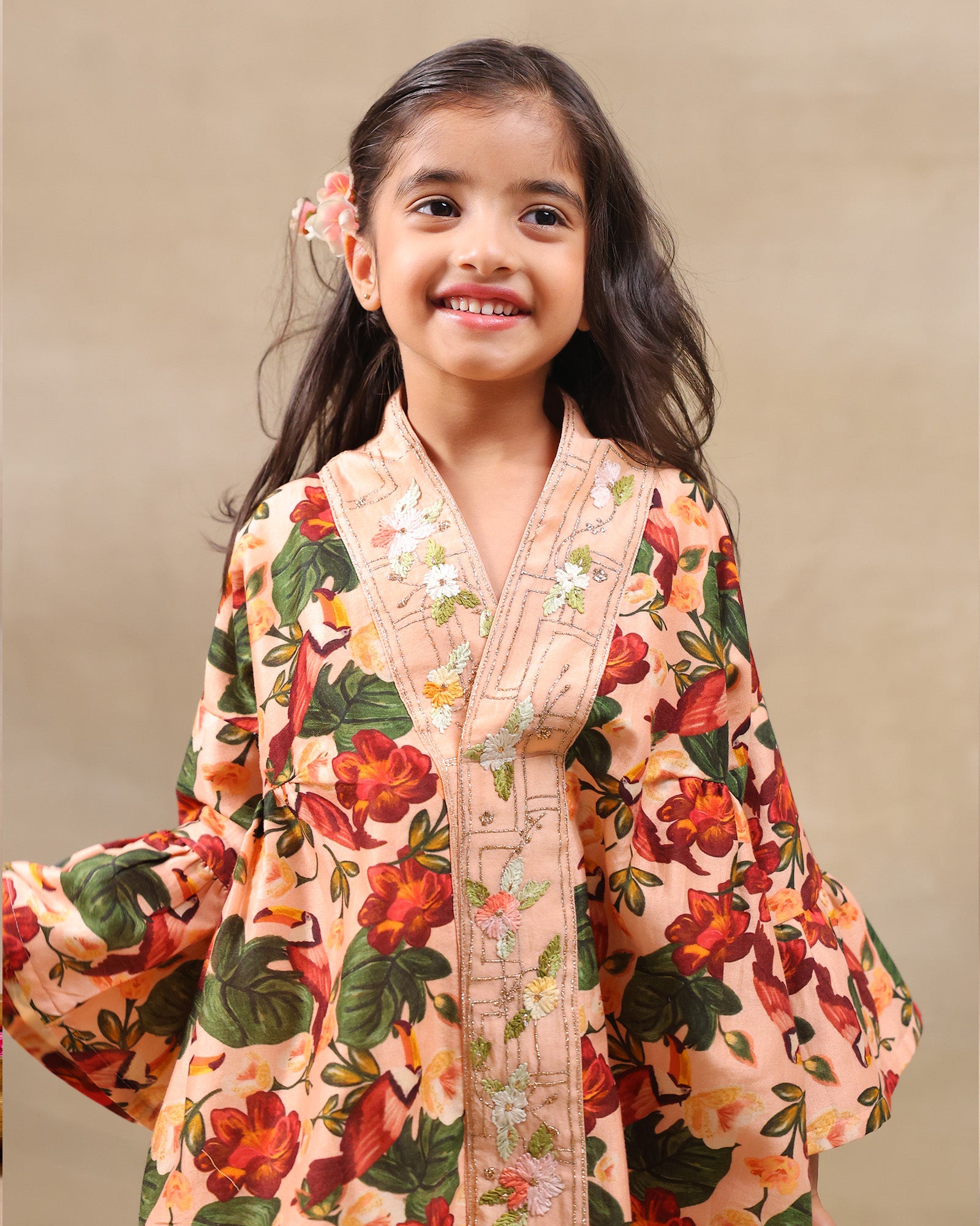 Girl wearing GLUBAGH PEACH SHARARA a handcrafted floral red kimono style top with embroidered neckline and flared ivory sharara pants – ethnic festive kidswear by LAAD