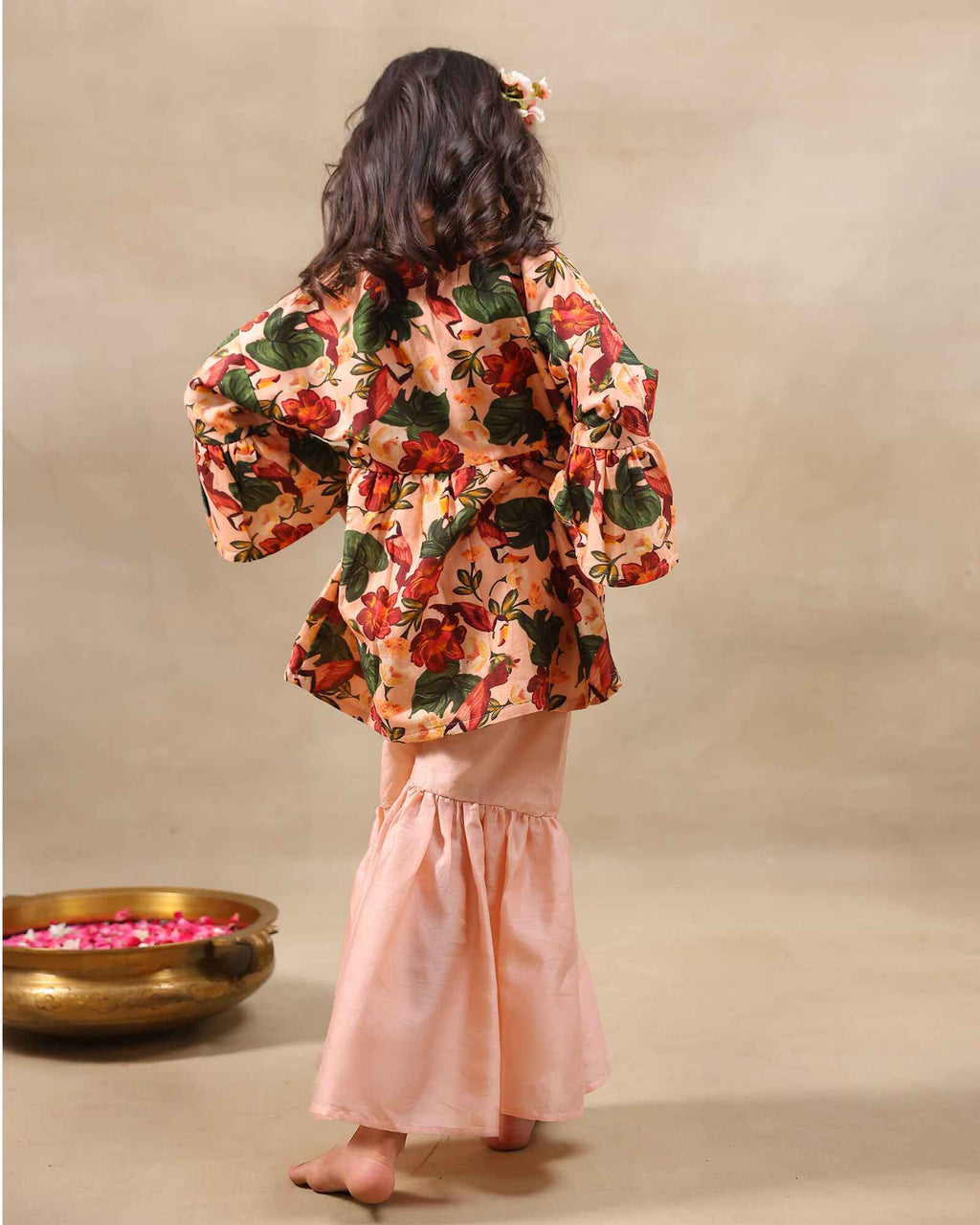 Girl wearing GLUBAGH PEACH SHARARA a handcrafted floral red kimono style top with embroidered neckline and flared ivory sharara pants – its perfect traditional kurta pyjama , kids ethnic wear by LAAD