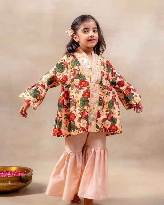 Girl wearing GLUBAGH PEACH SHARARA a handcrafted floral red kimono style top with embroidered neckline and flared ivory sharara pants – ethnic festive kidswear by LAAD