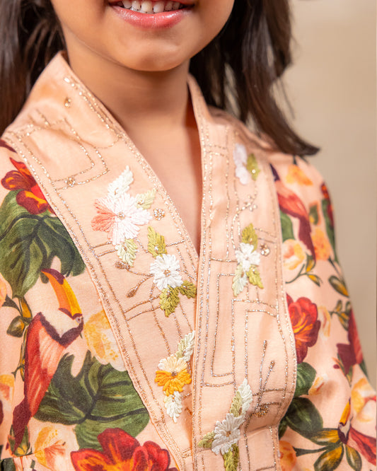 Girl wearing GLUBAGH PEACH SHARARA a handcrafted floral red kimono style top with embroidered neckline and flared ivory sharara pants – ethnic festive kidswear by LAAD