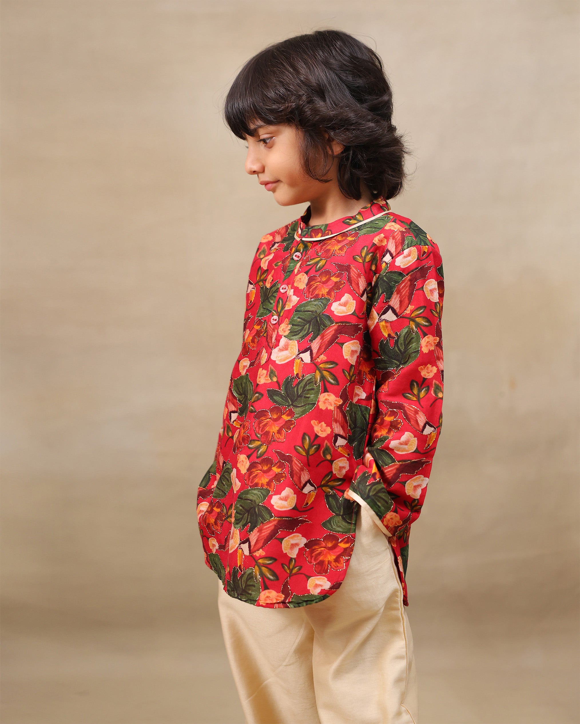 Young boy wearing a gulbagh kurta pyjama set with buttoned neckline and ivory straight pants – festive traditional kidswear by LAAD