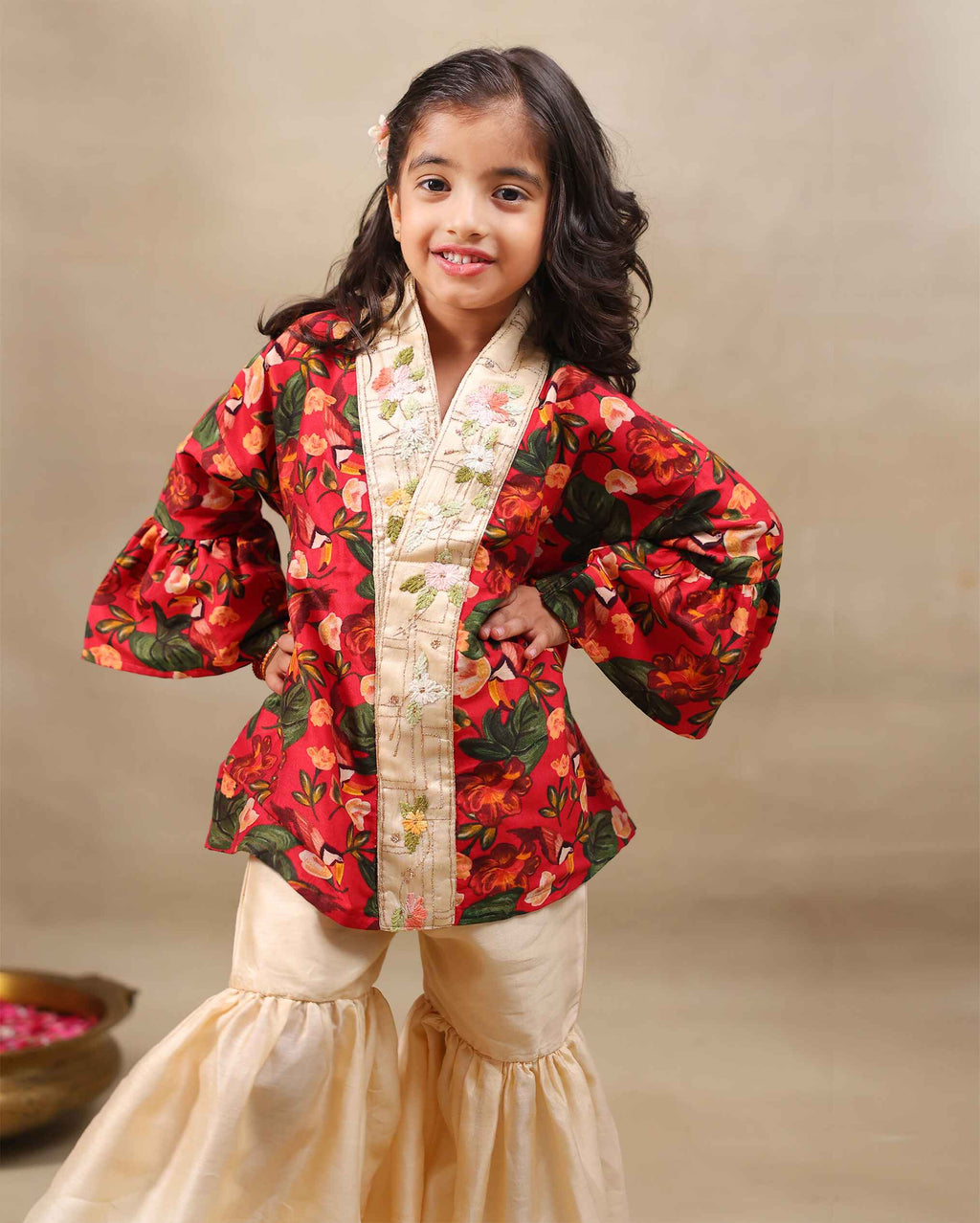 Girl wearing a handcrafted floral red kimono style party wear sharara with embroidered neckline and paired with  flared ivory sharara pants – perfect girls festive kidswear, occasion and celebration wear by LAADindia.