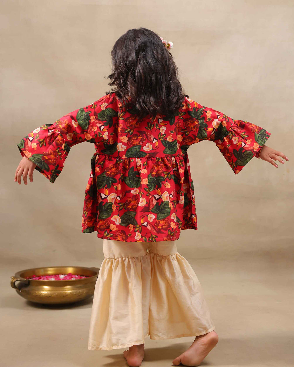 Girl wearing a handcrafted floral red kimono style party wear sharara with embroidered neckline and paired with  flared ivory sharara pants – perfect girls festive kidswear, occasion and celebration wear by LAADindia.