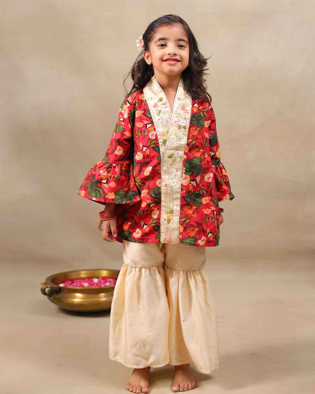 Girl wearing a handcrafted floral red kimono style party wear sharara with embroidered neckline and paired with  flared ivory sharara pants – perfect girls festive kidswear, occasion and celebration wear by LAADindia.