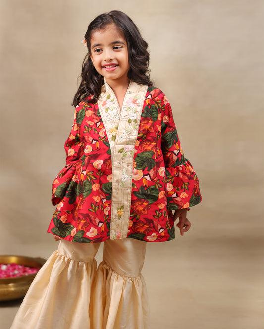 Girl wearing a handcrafted floral red kimono style top with embroidered neckline and flared ivory sharara pants – ethnic festive kidswear by LAAD