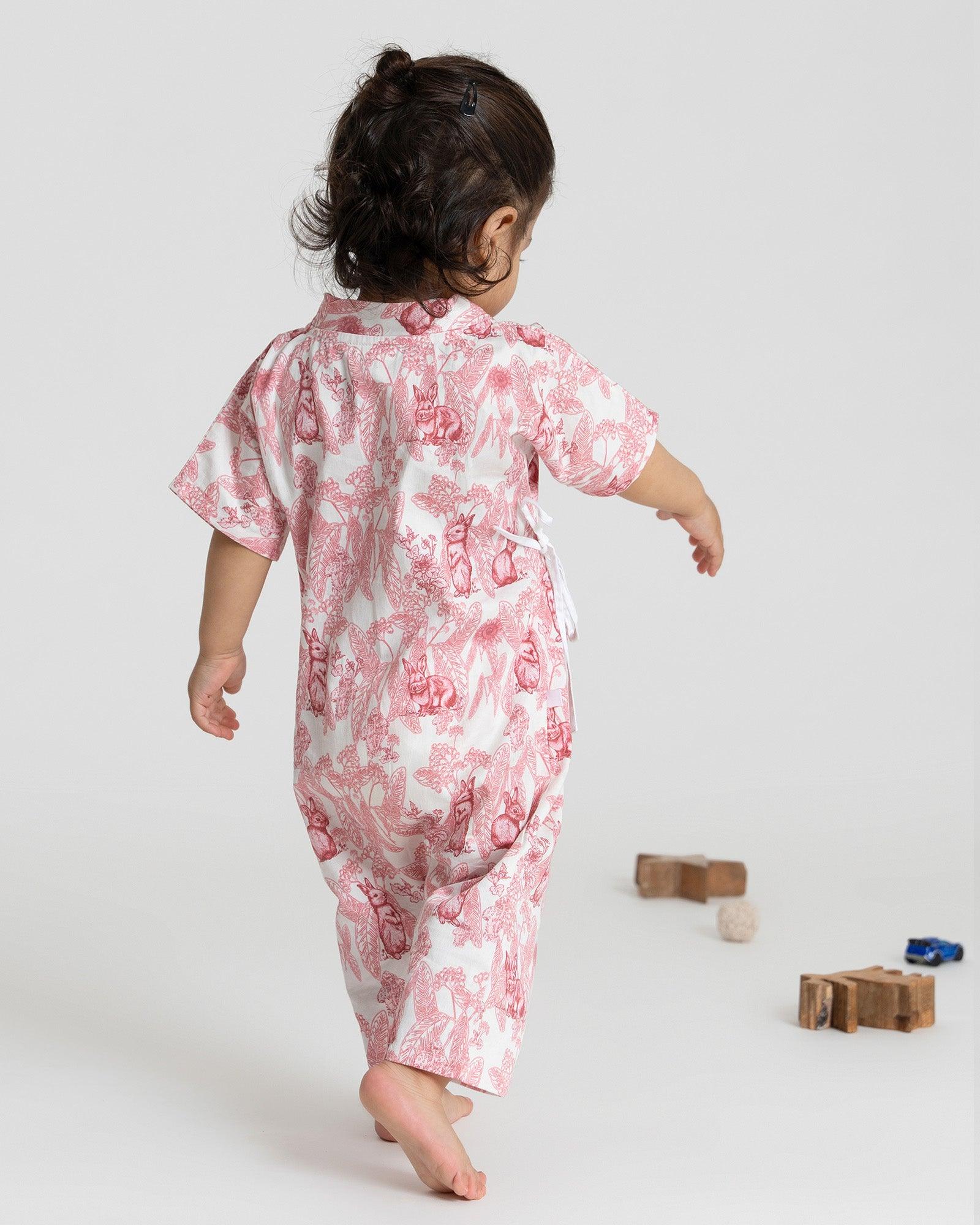 A premium cotton Kimono Romper with a whimsical bunny wonderland print in soothing pink tones. Featuring side tie closures for easy dressing and snap buttons at the crotch for quick diaper changes, this wrap-style romper offers a snug and adjustable fit. Made from 100% natural cotton