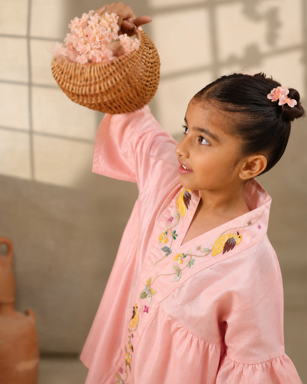 A young girl modeling a rosy kimono  flower look co-ord   set with colorful floral bird embroidery down the front placket by laandindia.com