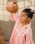 A young girl modeling a rosy kimono  flower look co-ord   set with colorful floral bird embroidery down the front placket by laandindia.com