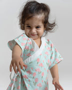happy toddler Laad`s girl wearing a mint green kimono-style romper with pink tulip floral print .