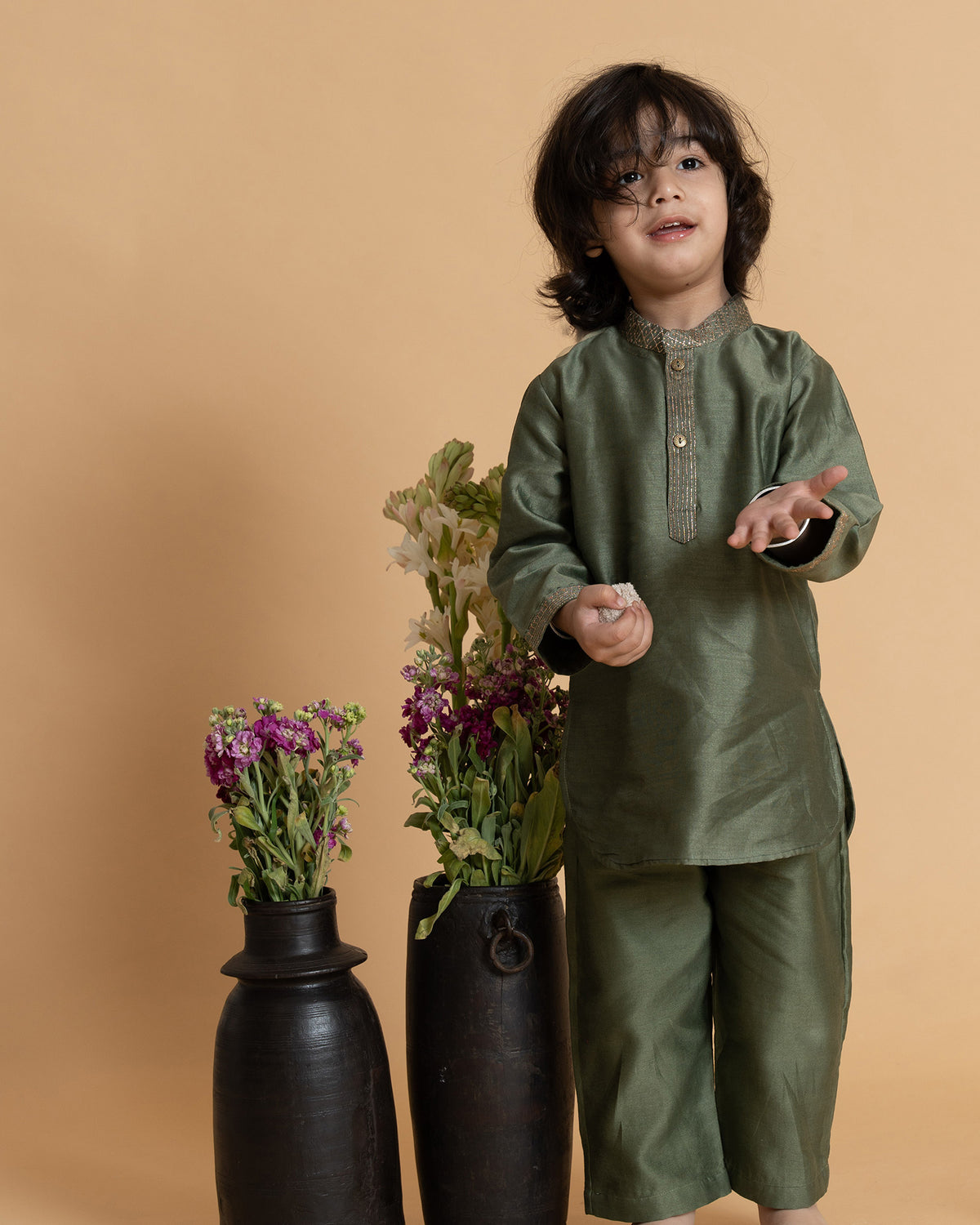 Little boy in a stylish moss green kurta set with delicate embroidery, showcasing festive elegance and comfort. Perfect ethnic wear for kids. 