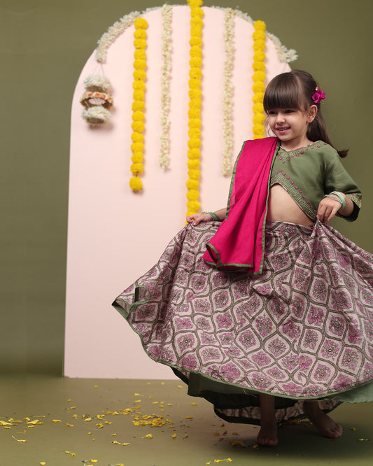 Indulge your child in elegance. Moss green lehenga, blouse, dupatta. Silk chanderi, cotton mulmul lining. Hand-embroidered, badla work, ari-handwork. Paisley prints, beads and trims perfect wedding attire. by laadindia.com