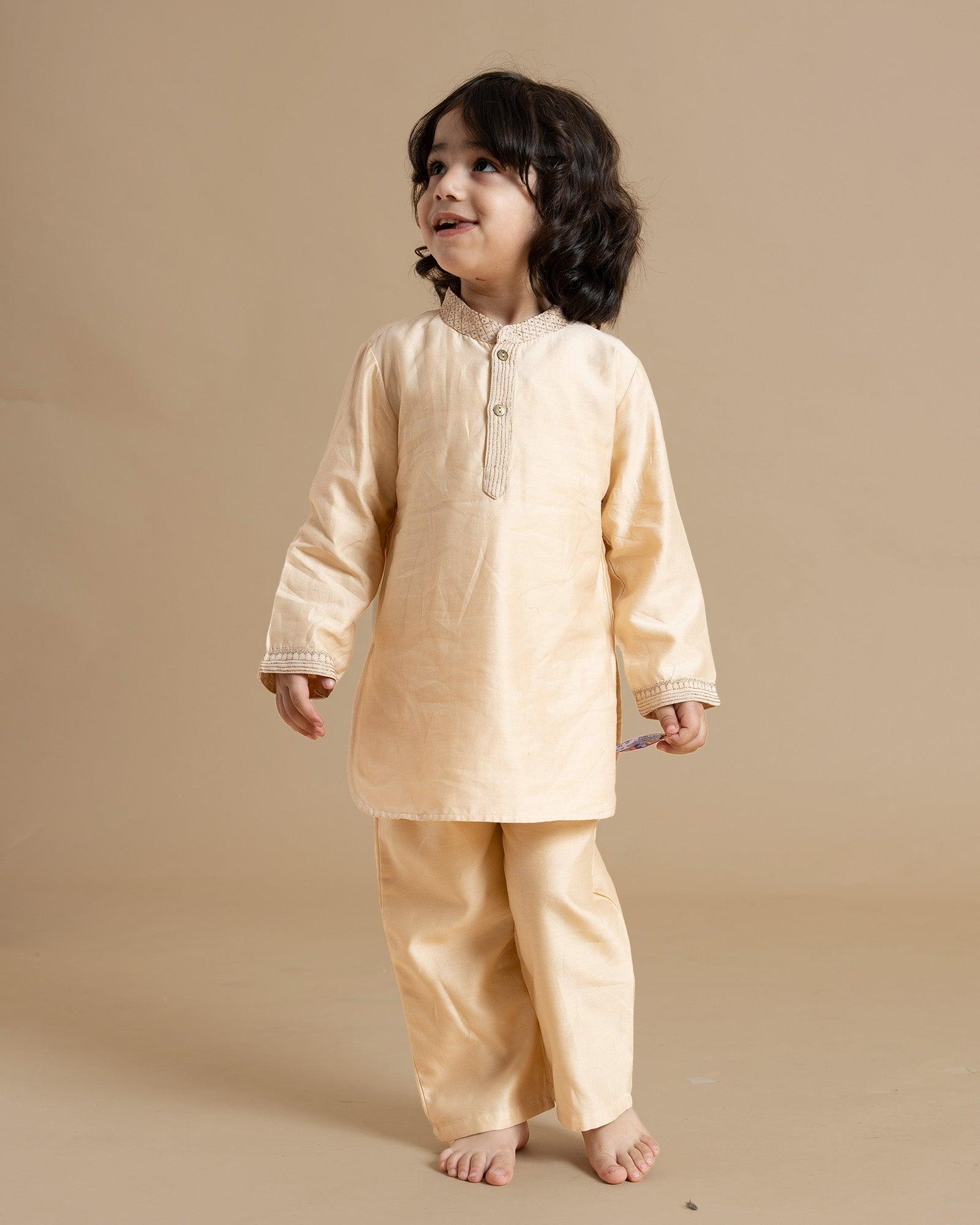 Little boy in a stylish Phulwari almond blush kurta set with delicate embroidery, showcasing festive elegance and comfort. Perfect ethnic wear for kids by laad.