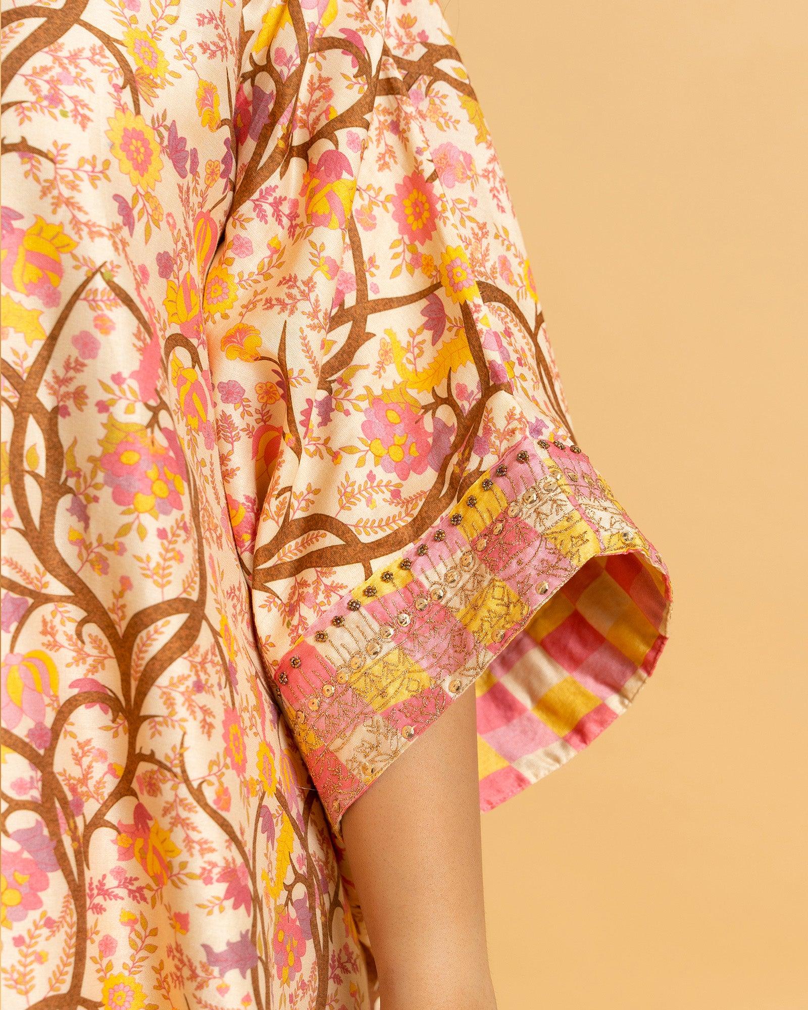 Capture spring's essence! Our Phulwari shades of spring kaftan (free size, boat neck) boast a blossom print & delicate embroidery. Flowing checkered palazzos graze the ankle.