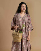 Phulwari's kaftan: V-neck & ambi-inspired print. Delicate embroidery, sleeve details. Flowing checkered palazzos. Comfy & stylish perfect festive wear