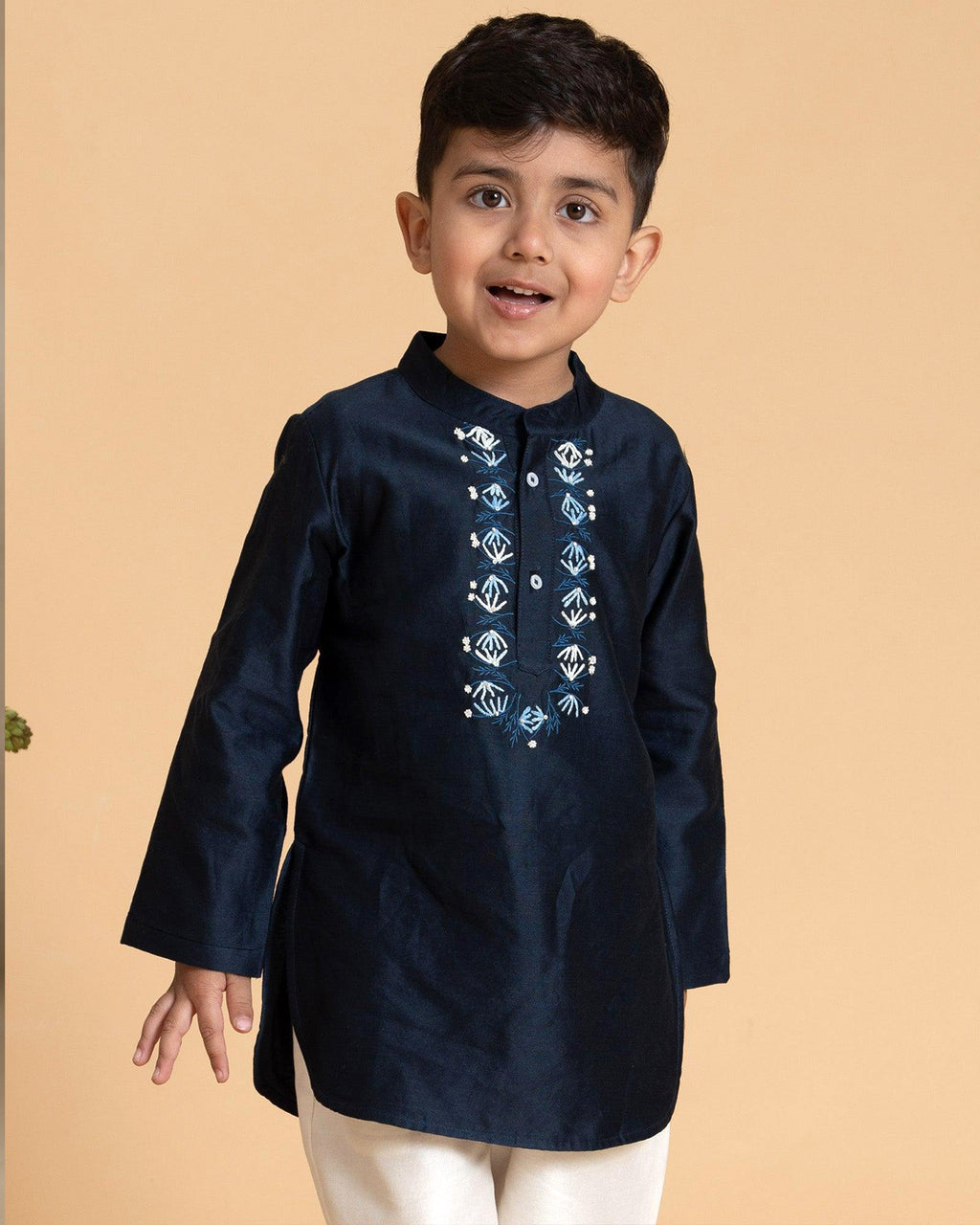 laad`s kid in marine blue kurta with embroidered details on placket, paired  with off white trousers