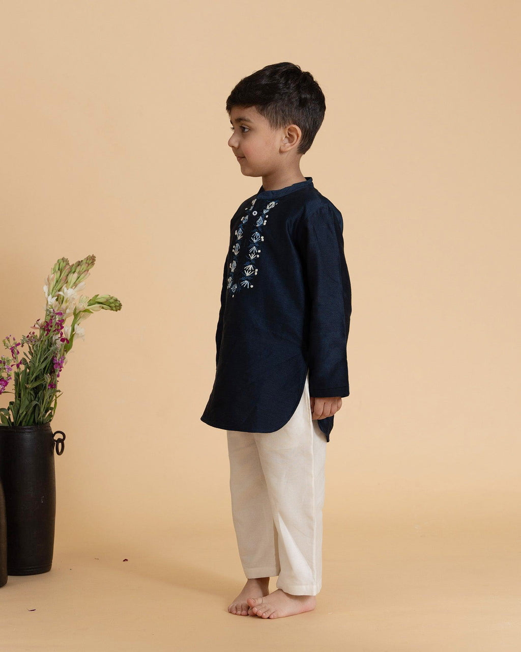 laad`s kid in marine blue kurta with embroidered details on placket, paired  with off white trousers
