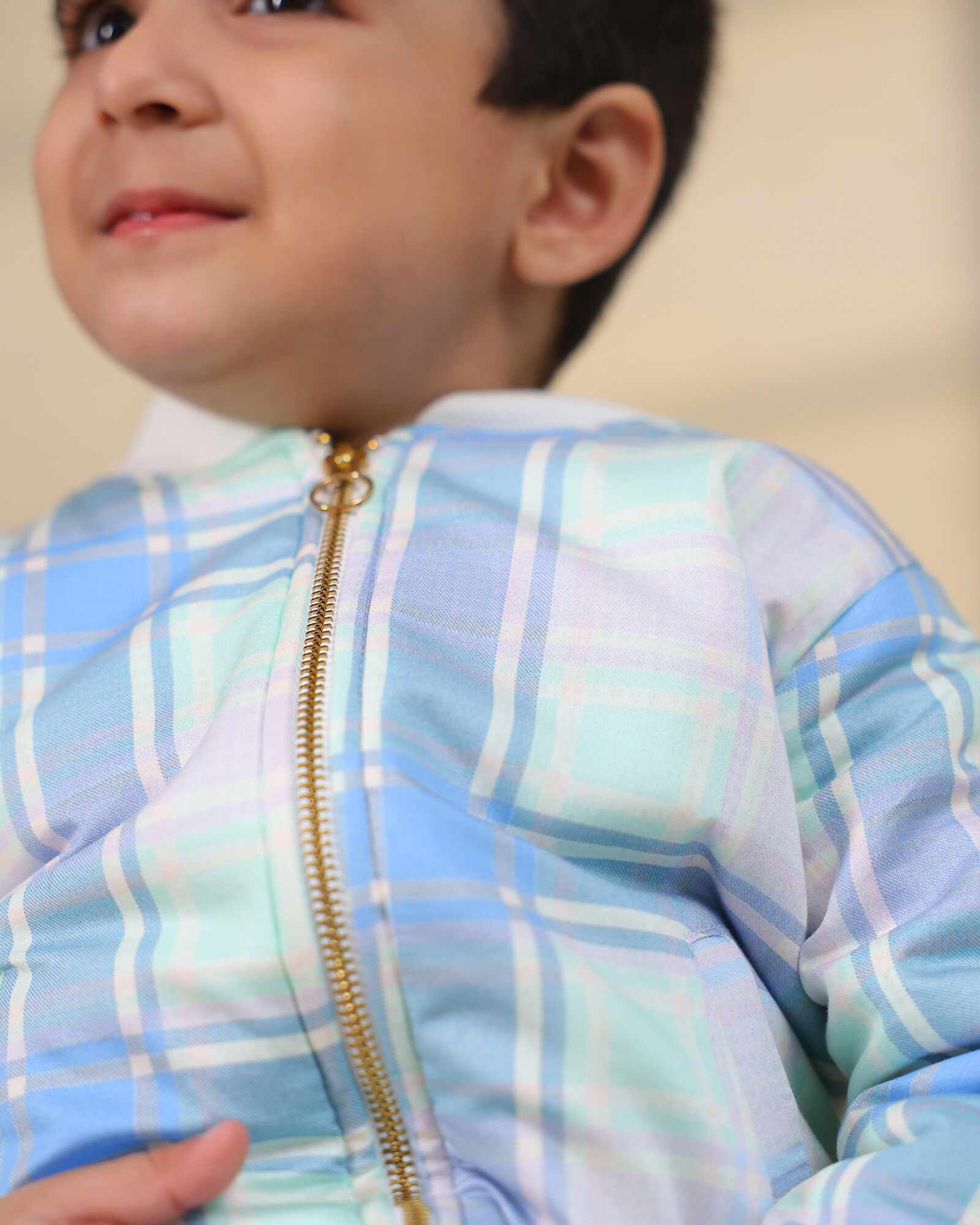 Boy kid wearing plaid check bomber jacket in soft cotton , perfect winter wear .