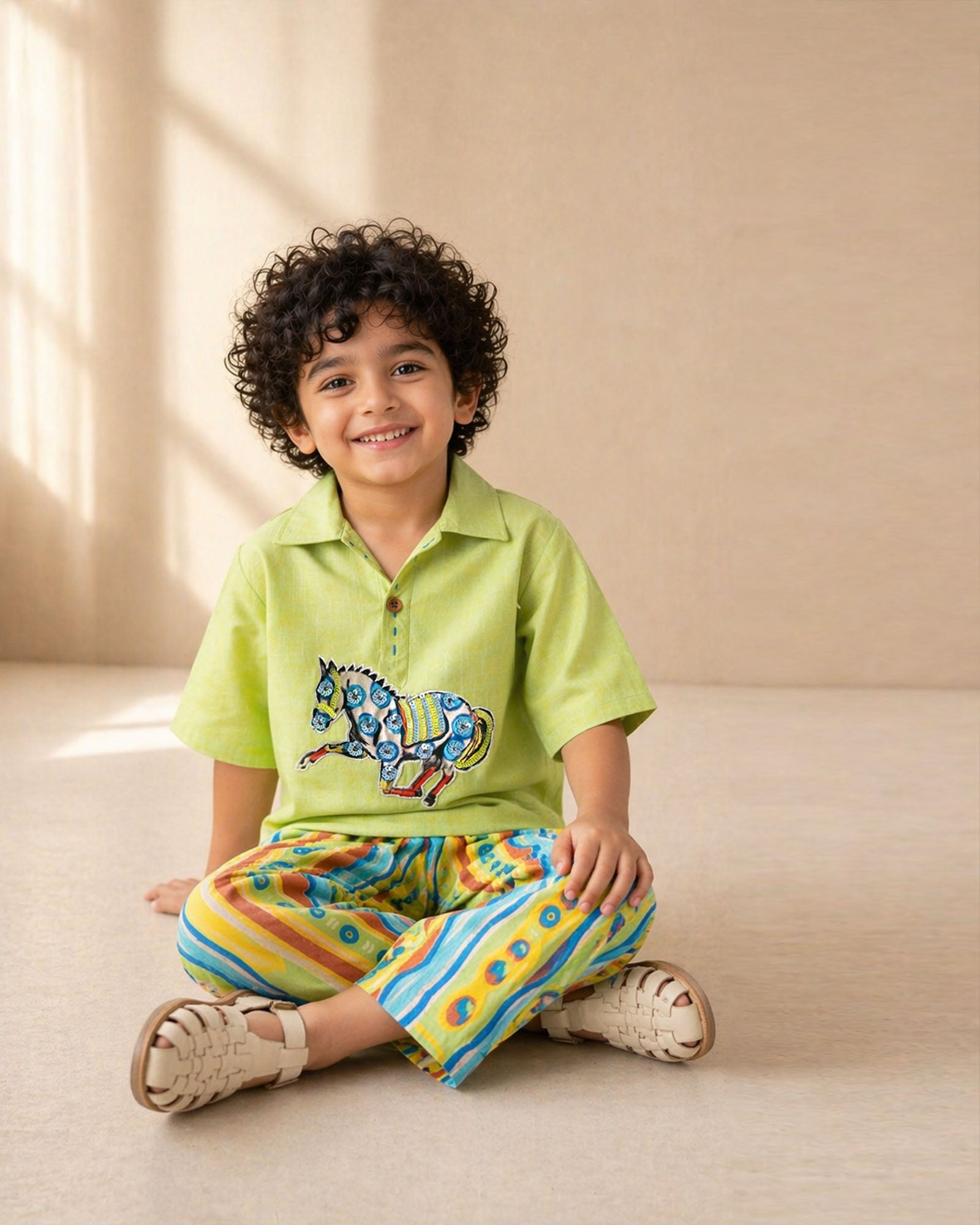 Lime green boys co-ord set with embroidered horse motif and vibrant striped pants by LAAD.