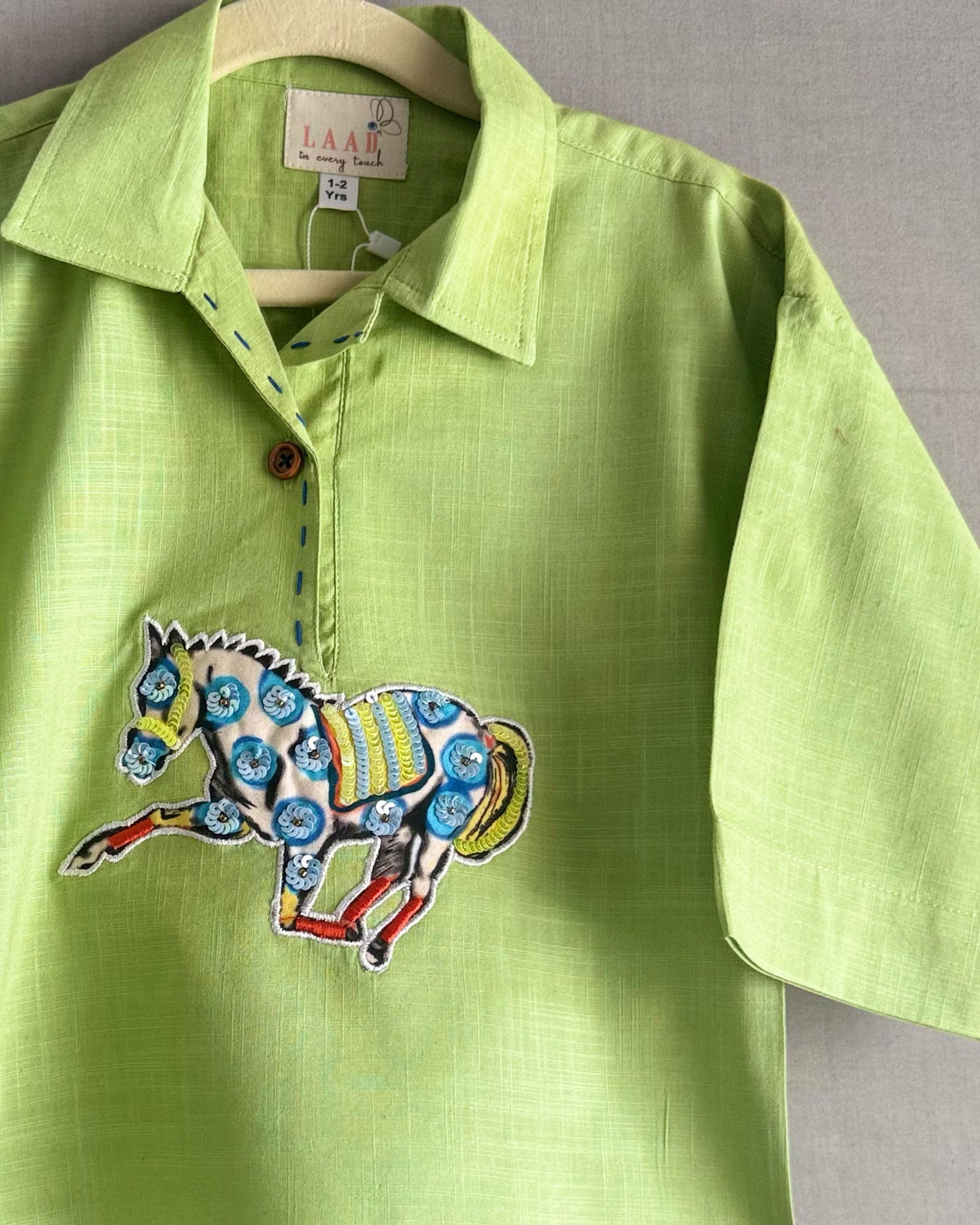 Lime green boys co-ord set with embroidered horse motif and vibrant striped pants by LAAD.