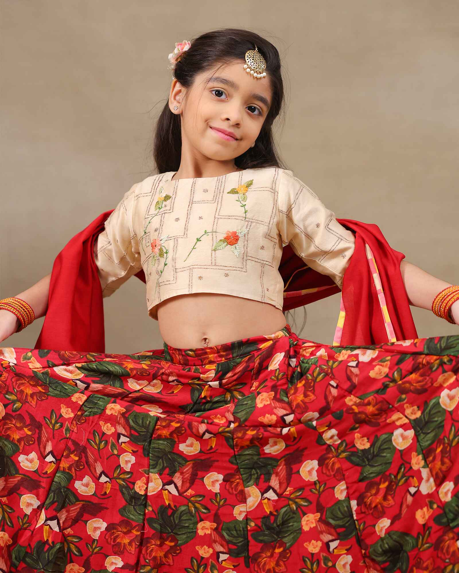 Young girl wearing LAAD’s floral red rose lehenga set with embroidered perfect net lehenga choli with dupatta girls festive wear for kids, perfect for weddings and celebrations.