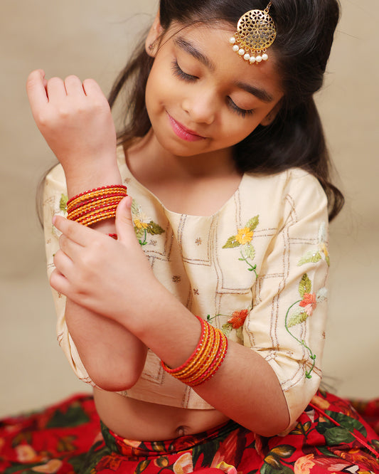 Young girl wearing LAAD’s floral red rose lehenga set with embroidered blouse and dupatta – festive ethnic wear for kids, perfect for weddings and celebrations.

