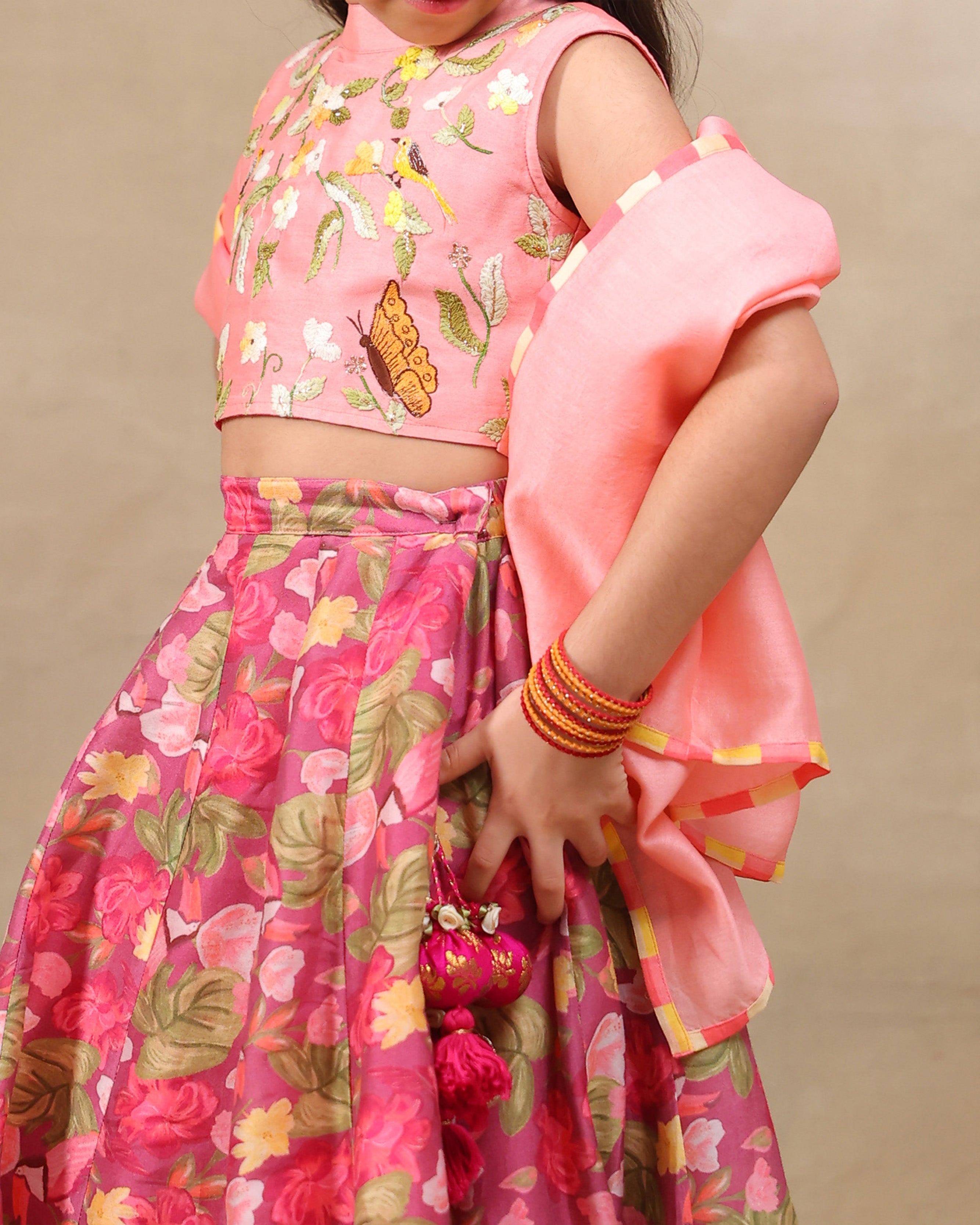 Girl in festive pink floral rosy ruffle   lehenga set with embroidered crop top – handcrafted kids ethnic wear by LAAD
