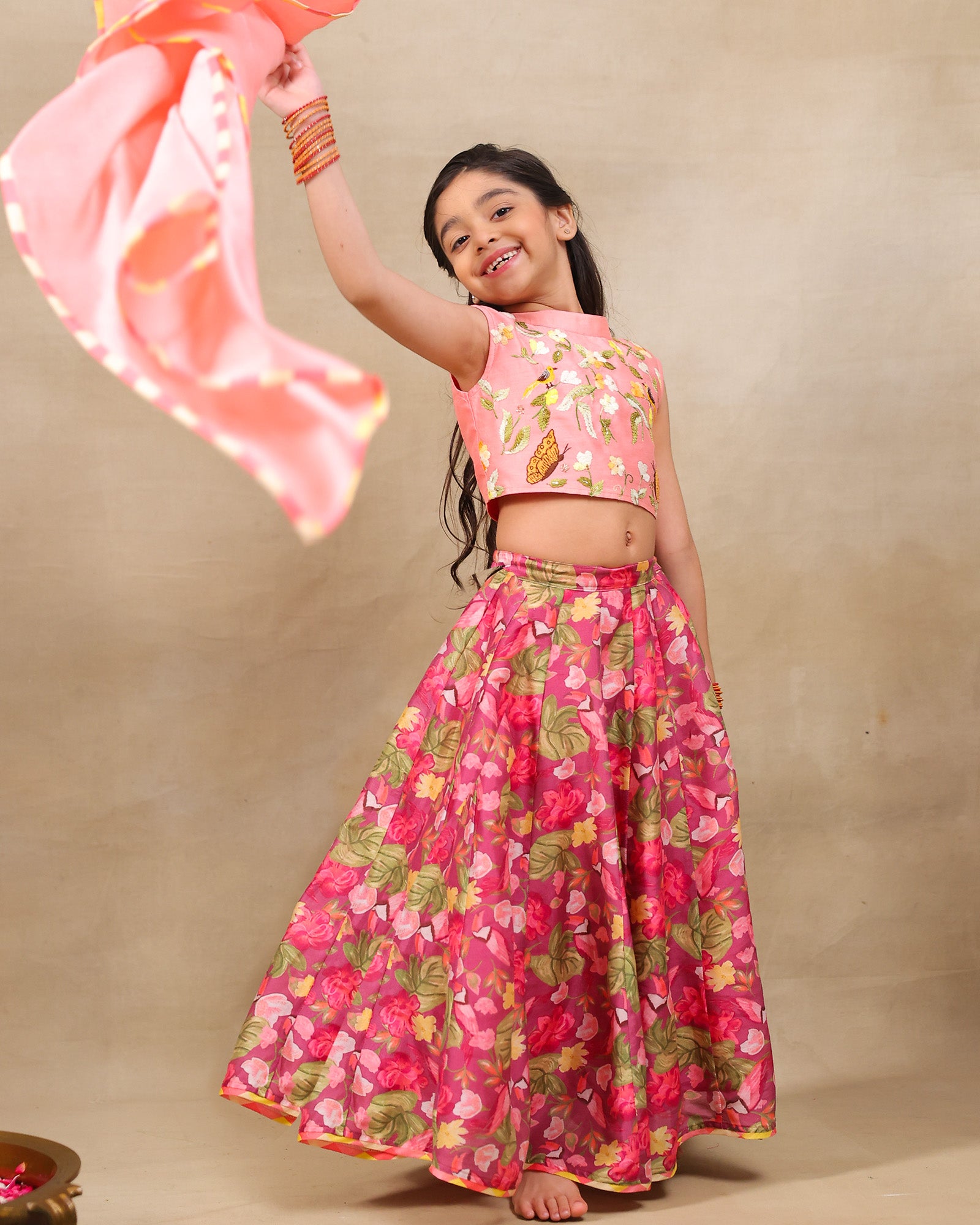 Girl in festive pink floral lehenga set with embroidered crop top – handcrafted kids ethnic wear by LAAD