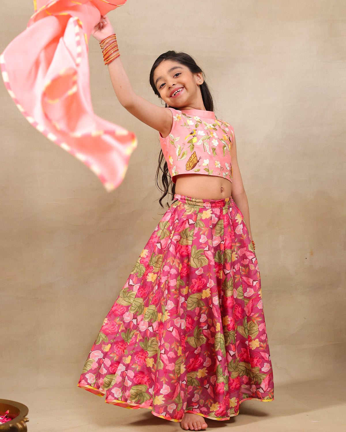 Girl in festive pink floral lehenga set with embroidered crop top – handcrafted kids ethnic wear by LAAD